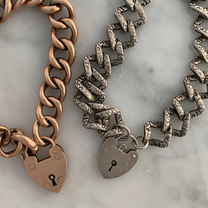 This Vintage Silver Lock Bracelet features a heart shaped lock that is able to open, on a 7" curb chain. On one side of the chain are hand engraved markings, giving the bracelet an edgy feel. Worn simply on its own or made into a statement piece by adding charms, this bracelet has many possibilities.