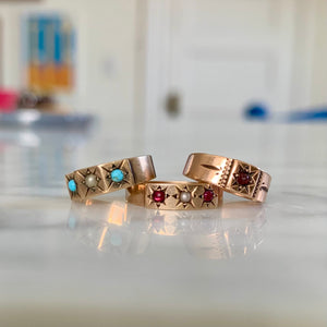 In the Victorian era, these tiny 14K rings were baby rings. They are beautiful examples of classic Victorian styling featuring genuine stones in a starburst setting. Wear them on one of our antique gold chains as a necklace or off as a pinky or midi ring, front view