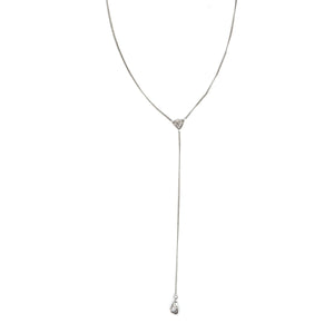 This art deco lorgnette chain measures 24" in length with a 4.5" extension. It features an extremely delicate curb link and an ornamental triangle at the base of the extension. In the Victorian era, lorgnettes carried eyeglasses, but we think it pairs beautifully with one of our vintage lockets or charms. Close up view,