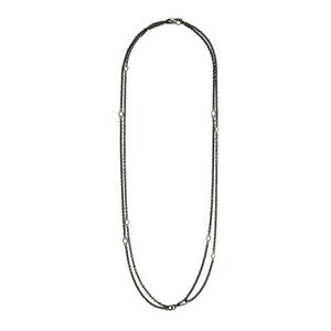 This long Victorian gunmetal chain measures 52" in length and features 10 incredibly cut glass stones. Doubled up on a watch chain clasp, it is nearly 26" in length and is unique on its own or pairs perfectly with one of our vintage lockets. Full chain view