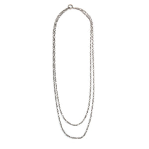This vintage silver chain measures 52" in length and features figaro links and a spring ring clasp. This chain pairs perfectly with one of our vintage lockets or pendants and can be worn on it's own doubled or long and layered. Full chain view