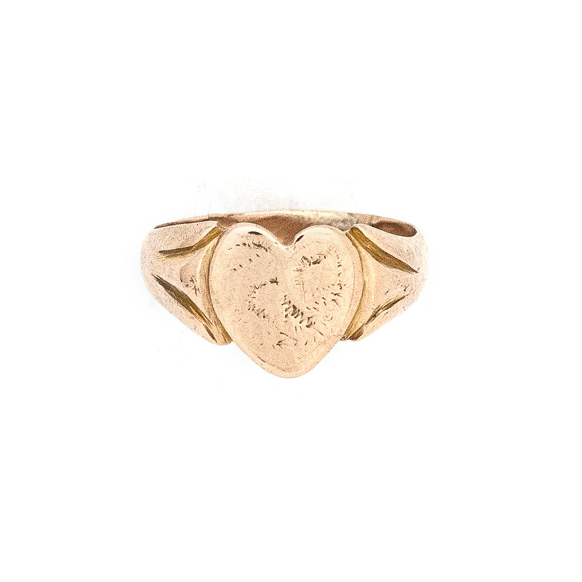This warm, rosy-hued 12K gold signet ring features a large heart cradled by fluted shoulders. The heart once held a monogram, which has been buffed away, allowing space for a new monogram if desired.  Its wide band which makes it extra comfortable to wear -- it feels like love in a ring!  Front ring view