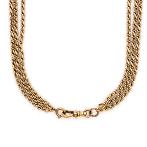 This 12K gold fill antique rope chain features three gorgeous strands of varying lengths (18", 27" and 34") which meet together at the back with a hefty watch chain hook. Wear this striking piece alone or layered with your favorite pieces for a bold statement. Close up view, showing clasp