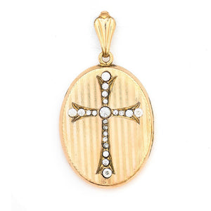This oval locket features a white paste stone encrusted cross with a pinstripe backdrop. The letter EM are inscribed on the back. It opens to hold two photos, includes one original frame and pairs perfectly with one of our antique gold fill chains. Front Locket view