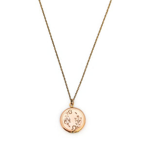 This petite round locket features a playful daisy pattern and a finely etched zigzag design around the border. It opens to hold two photos and pairs perfectly with one of our antique gold fill chains. Front Locket View, Shown on Chain