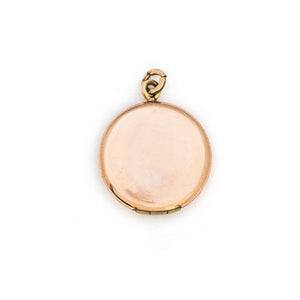 This petite round locket features a playful daisy pattern and a finely etched zigzag design around the border. It opens to hold two photos and pairs perfectly with one of our antique gold fill chains. Back Locket View