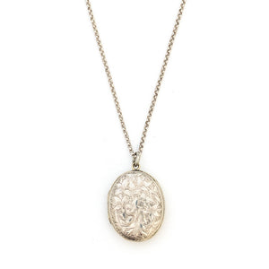 This sterling silver oval locket features a detailed garden vine pattern that covers the entire face of the locket. It opens to hold two photos, includes both original frames and pairs perfectly with one of our vintage sterling silver chains. Front Locket View, Shown on chain