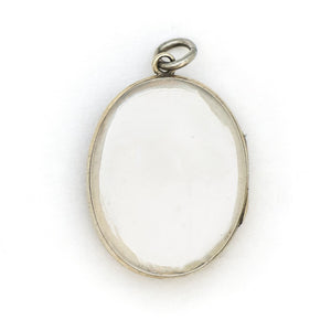 This sterling silver oval locket features a detailed garden vine pattern that covers the entire face of the locket. It opens to hold two photos, includes both original frames and pairs perfectly with one of our vintage sterling silver chains. Back Locket View