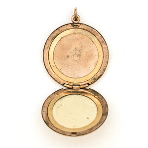 This spirited round locket features an explosive fireworks design enhanced by 21 white Victorian paste stones. It opens to hold two photos, includes both original frames and pairs perfectly with one of our antique gold fill chains. Open Locket View