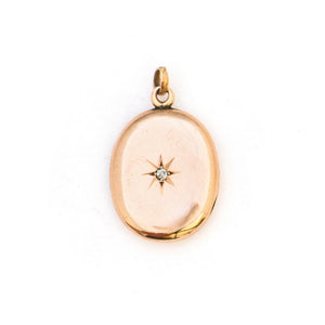 This classic oval 10K gold locket features a simple Victorian starburst with a genuine diamond at it's center and the letters JFD inscribed on the back. It opens to hold two photos, includes one original frame and pairs perfectly with one of our antique 14K gold chains. Front Locket View