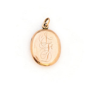 This classic oval 10K gold locket features a simple Victorian starburst with a genuine diamond at it's center and the letters JFD inscribed on the back. It opens to hold two photos, includes one original frame and pairs perfectly with one of our antique 14K gold chains. Back Locket View