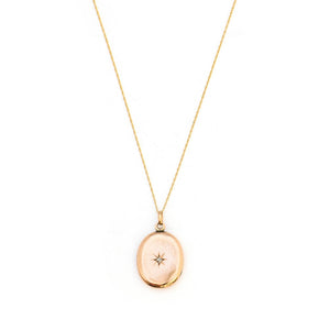 This classic oval 10K gold locket features a simple Victorian starburst with a genuine diamond at it's center and the letters JFD inscribed on the back. It opens to hold two photos, includes one original frame and pairs perfectly with one of our antique 14K gold chains. Front Locket View, Shown on Chain