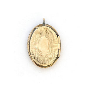 This unusual 10K gold oval locket features extremely intricate Niello technique with use of both yellow and rose gold and silver, a truly unique piece! It opens to hold two photos, includes both original frames and pairs perfectly with one of our antique 14K gold chains. Back locket view