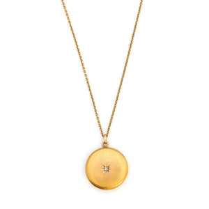 This 10K matte gold locket features a Victorian starburst with a 3 point diamond at its center. The initials MLA are elegantly inscribed on the back. It opens to hold two photos, includes both original frames and pairs perfectly with one of our antique 14K gold chains. Front Locket view, shown on chain