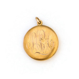 This 10K matte gold locket features a Victorian starburst with a 3 point diamond at its center. The initials MLA are elegantly inscribed on the back. It opens to hold two photos, includes both original frames and pairs perfectly with one of our antique 14K gold chains. Back locket view