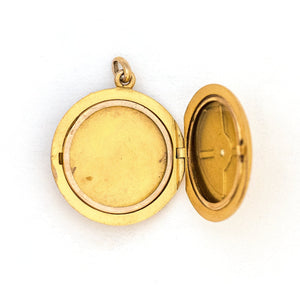 This 10K matte gold locket features a Victorian starburst with a 3 point diamond at its center. The initials MLA are elegantly inscribed on the back. It opens to hold two photos, includes both original frames and pairs perfectly with one of our antique 14K gold chains. Locket open view