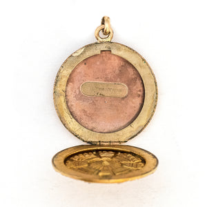 This striking round locket features an opal at it's center with intricate multi layered details and white paste stones radiating out in a sun-like pattern. It opens to hold two photos and pairs perfectly with one of our antique gold fill chains, open locket view