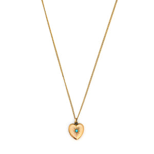 This petite heart shaped locket features a classic Victorian starburst with turquoise at it's center. It opens to hold two photos, includes both original frames and pairs perfectly with one of our antique gold fill chains. Front Locket View, shown on chain