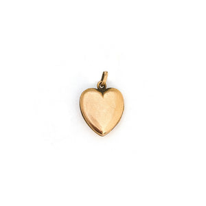 This petite heart shaped locket features a classic Victorian starburst with turquoise at it's center. It opens to hold two photos, includes both original frames and pairs perfectly with one of our antique gold fill chains. Back locket view
