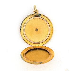 This large round locket features a classic Victorian starburst with a 3.5 mm white paste stone at the center. It opens to hold two photos, includes both original frames and pairs perfectly with one of our antique gold fill chains. Open locket view