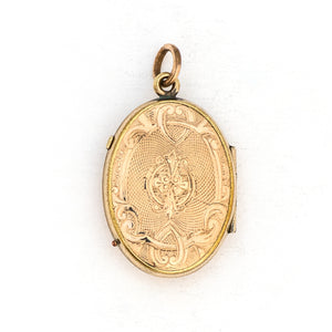 This oval locket features a gorgeous light blue and black enamel design with a finely textured background. It opens to hold two photos and pairs perfectly with one of our antique gold fill chains. Back Locket view