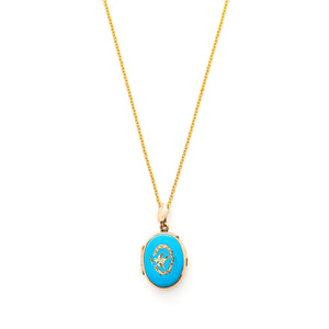 This absolutely gorgeous robin egg blue enamel and gold fill locket is oval shaped and features a sparrow carrying a scroll in it's beak. The sparrow is surrounded by an intricate golden wreath. It opens to hold two photos, includes both original frames and glass, and pairs perfectly with one of our antique gold fill chains. Front Locket View, shown on chain