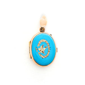 This absolutely gorgeous robin egg blue enamel and gold fill locket is oval shaped and features a sparrow carrying a scroll in it's beak. The sparrow is surrounded by an intricate golden wreath. It opens to hold two photos, includes both original frames and glass, and pairs perfectly with one of our antique gold fill chains. Front Locket View