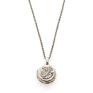 This round sterling silver Victorian locket features a woman lying in a crescent moon surrounded by stars. It opens to hold two photos and pairs perfectly with one of our antique sterling silver chains. Front locket view shown on chain