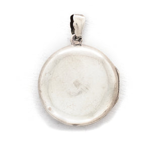 This round sterling silver Victorian locket features a woman lying in a crescent moon surrounded by stars. It opens to hold two photos and pairs perfectly with one of our antique sterling silver chains. Back locket view