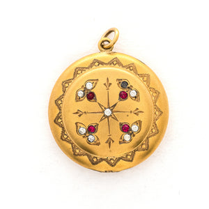 This incredibly unique gold fill locket features red and white paste stones surrounding a central starburst. This locket has two compartments: one that holds a photo, original frame included, and a second secret compartment that holds a tiny sachet. The inscribed text inside the locket tells us this design was patent pending (See photos). We've never seen anything like it! This gem pairs perfectly with one of our antique gold fill chains. Front locket view