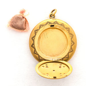 This incredibly unique gold fill locket features red and white paste stones surrounding a central starburst. This locket has two compartments: one that holds a photo, original frame included, and a second secret compartment that holds a tiny sachet. The inscribed text inside the locket tells us this design was patent pending (See photos). We've never seen anything like it! This gem pairs perfectly with one of our antique gold fill chains. Open locket, showing sachet