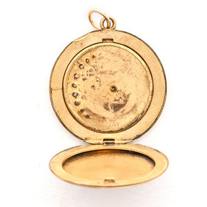 This classic Victorian locket features a large crescent moon surrounding a bright starburst with 10 white Victorian paste stones throughout the design. It opens to hold two photos, includes one original frame and pairs perfectly with one of our antique gold fill chains. Open locket view