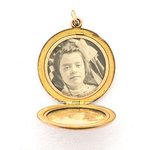 This round, matte locket features an ornate "S" in Victorian era script on the front and the initials MLC on the back. It opens to hold two photos, includes both original frames and pairs perfectly with one of our antique gold fill chains. Open locket view