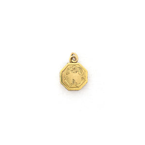 This petite octagonal locket features a delicately etched floral motif including a classic Victorian era symbol, the forget-me-not flower at the top of the design. It opens to hold two (very tiny!) photos and pairs perfectly with one of our antique gold fill chains. Front locket view