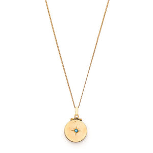This petite circular locket features a classic Victorian starburst with a gorgeous opal at it's center. It opens to hold two photos and pairs perfectly with one of our antique gold fill chains. Front Locket view, shown on chain