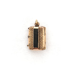 This petite rectangular locket features a basket weave pattern with a seed pearl on one side and a strip of black onyx on the other. It opens to hold two photos, includes both original frames and glass and pairs perfectly with one of our antique gold fill chains. Back locket view