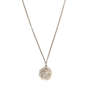 This horseshoe-shaped oval English sterling silver locket features two star flowers and one leaf in raised relief with delicately etched stems and leaves in the background. It has been hallmarked for Birmingham, 1901, opens to hold two photos and pairs perfectly with one of our vintage sterling silver chains. Front locket view, shown on chain