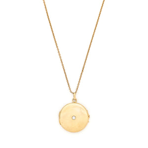 This beautifully simple 14K gold locket features a 10 point genuine diamond at its center. It opens to hold one photo, includes one original frame and pairs perfectly with one of our antique 14K gold chains. Front locket view, shown on chain