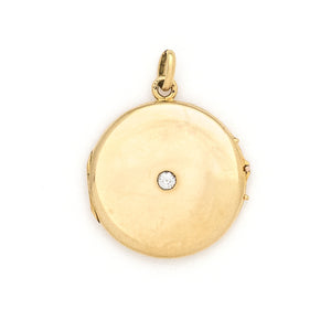 This beautifully simple 14K gold locket features a 10 point genuine diamond at its center. It opens to hold one photo, includes one original frame and pairs perfectly with one of our antique 14K gold chains. Front locket view