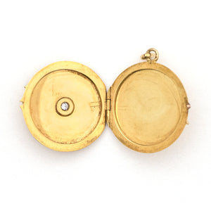 This beautifully simple 14K gold locket features a 10 point genuine diamond at its center. It opens to hold one photo, includes one original frame and pairs perfectly with one of our antique 14K gold chains. Open locket view
