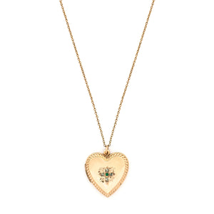 This sweet heart-shaped locket features white and green paste stones set in an equal-sided Greek cross at its center, surrounded by a charming rope border. In antiquity, the equal arms of a Greek cross symbolized the four main elements of nature: air, fire, water, earth. The locket opens to hold two photos, includes both original frames and pairs perfectly with one of our antique gold fill chains. Front locket view, shown on chain