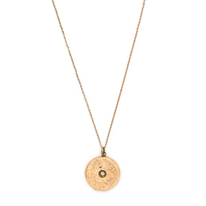 This romantic round Edwardian locket features a playful swirling pattern framing a sizable white paste stone at its center, and a polished verso. It opens to hold two photos, includes both original frames and pairs perfectly with one of our antique gold fill chains. Front locket view, shown on chain