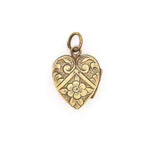 This sweet vintage heart-shaped locket features seven white glass stones in the shape of a snowflake with an intricate forget-me-not design on the back. It opens to hold one photo, includes one original frame and pairs perfectly with one of our antique gold fill chains. Back locket view