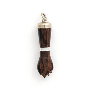 This unique figa hand charm is made of walnut wood and features sterling silver accents including the bail and a bracelet on the wrist. The figa symbol dates back to ancient times and in modern day is seen as a sign of female strength and empowerment. Paired with one of our antique sterling silver chains, this charm can be worn both as a pendant or in a cluster of charms. Charm view