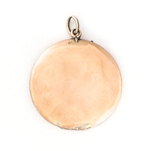 This striking round locket features red stones in a pleasing art deco style pattern. It opens to hold two photos and pairs perfectly with one of our antique gold fill chains. Back locket view