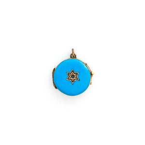 This petite round locket features striking cerulean blue enamel with a 14K gold Star of David at its center and a matching 14K gold border. It opens to hold two photos, includes one original glass and pairs perfectly with one of our antique gold chains. Front locket view