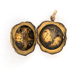 This incredible round locket features a sculpted pansy with a turquoise stone at its center. It is sterling silver with a gold wash and the textured petals catch the light at every turn. It opens to hold two photos and pairs perfectly with one of our antique sterling silver or gold fill chains. Open locket view