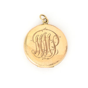 This radiant round locket features encrusted flourishes with the north star at its center. The initials MMP are inscribed on the back, it opens to hold two photos, includes both original frames and pairs perfectly with one of our antique gold fill chains. Back locket view