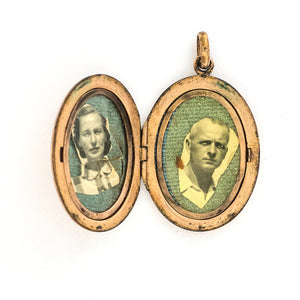 This oval locket features a simple Art Deco design with two red floral vines hanging down the center. It opens to hold two photos, includes both original frames and pairs perfectly with one of our antique gold fill chains. Open locket view