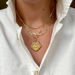 Long bar link chain shown with gold fill locket